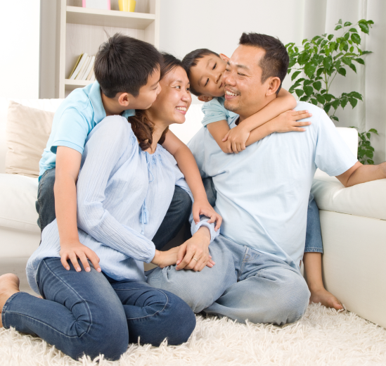 Family smiling and hugging in living room